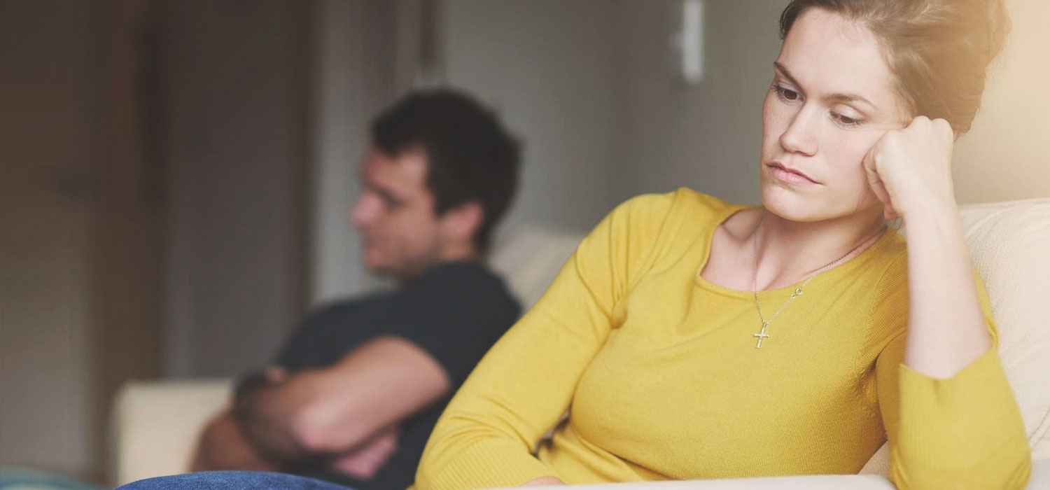 unhappy couple on couch